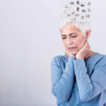 Elderly woman with a unique hairstyle made of puzzle pieces, looking thoughtful