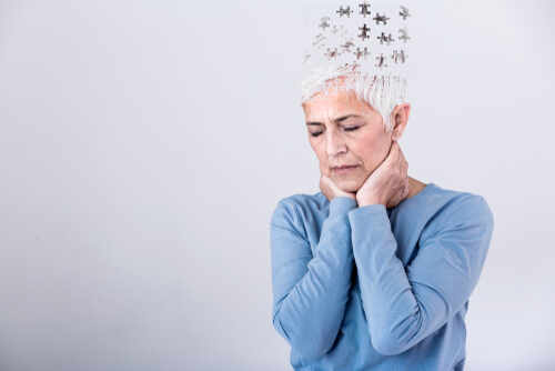 shutterstock_1572196636 (1).jpg Elderly woman with a unique hairstyle made of puzzle pieces, looking thoughtful