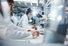 Cancer Study Reveals Dangerous Plastic Link Scientists working in a laboratory with microscopes and test tubes