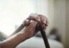 The Best Lifespan Predictor Close-up of elderly hands resting on a cane