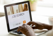 Introverts: Stop Chasing Titles, Start Chasing Fit Person using a laptop for job searching