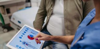 Nurse showing a patient health data on a tablet