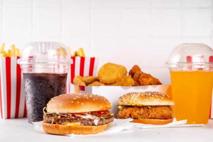 A variety of fast food items including burgers, fries, and drinks