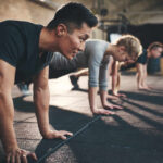 The Simple Formula for Muscle Preservation Group of individuals performing push-ups in a gym