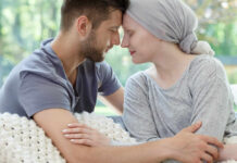 A couple sharing a tender moment, foreheads touching, in a cozy setting