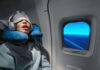 Sleep Apnea’s Secret Muscle Sabotage A passenger sleeping on an airplane with headphones and an eye mask