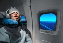 Sleep Apnea’s Secret Muscle Sabotage A passenger sleeping on an airplane with headphones and an eye mask