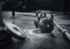 Kettlebells and weights on a gym floor with chalk dust