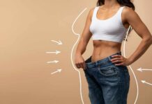 “Skinny Fat” Epidemic: Are You at Risk? Woman showcasing weight loss by holding oversized jeans
