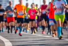 The 100-Mile Summer Fitness Phenomenon A group of runners participating in a marathon on a sunny day