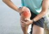 Collagen’s Shocking Impact on Your Bone Health! Athlete holding their knee in pain while exercising outdoors