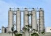 Coal Mining and Cancer Surge Metal storage silos against a blue sky