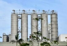 Metal storage silos against a blue sky