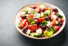 Low-Protein Diet Sparks Lifespan Debate A vibrant salad with tomatoes, cucumbers, olives, and feta cheese