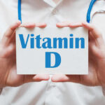 Medical professional holding a card that says 'Vitamin D'