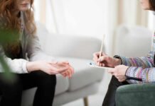 Mayo Clinic Wellness Playbook – How to Define Your Personal Values Two individuals engaged in a counseling session, one taking notes