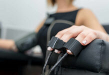 FDA-Approved Renal Denervation Lowers Blood Pressure Close-up of a patients hand during a medical examination with monitoring equipment