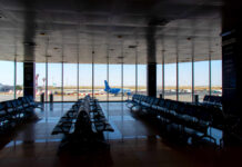 Longevity Hack Hiding In Plane Tickets Airport departure lounge with empty seating facing large windows