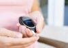 The Hidden Fat That Quietly Predicts Your Diabetes Risk Person using a blood glucose meter to check their levels