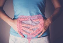 How Stress Ignites Gut Problems Person holding their stomach with a graphic of intestines overlayed