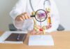 This Everyday Habit Protects Against Nanoplastics Doctor examining an anatomical model of the digestive system with a magnifying glass