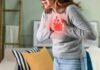 Why Heart Attacks Still Hit Active People Woman holding her chest in discomfort with a heart illustration