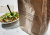 Fast Food, Faster Decline — Disturbing Link A Chipotle takeout bag next to a bowl filled with fresh salad ingredients