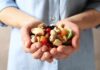 Hands holding mixed nuts and dried fruit