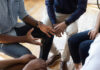 Celebrity Confession Upends Safe-Sex Rules A group of people engaged in a discussion with hands gesturing expressively