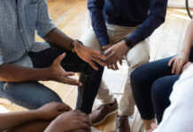 A group of people engaged in a discussion with hands gesturing expressively