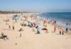 Beach Danger Most Miss — It’s Not Sharks Crowded beach with people sunbathing and playing in the water