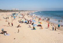 Beach Danger Most Miss — It’s Not Sharks Crowded beach with people sunbathing and playing in the water