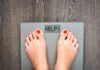 Calories Lie—The Real Obesity Trigger Feet on a digital bathroom scale displaying a help message