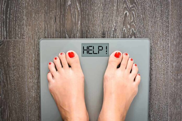 shutterstock_332045699 Feet on a digital bathroom scale displaying a help message