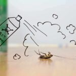 Dead cockroach on floor with drawn pest spray can and fumes