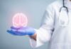 Want Better Memory? – Start Here A medical professional holding a glowing digital brain illustration in their hand
