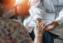Hidden Arthritis Triggers — Early Clues A doctor holding the hand of an elderly patient during a consultation