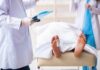 Doctors Sound Alarm: Why Men Keep Dying Earlier Than Women Medical staff stand near a covered body on a gurney with a toe tag
