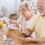 Sex and Gender Differences in Diabetes Risk Older man taking pills at a table while woman reads instructions