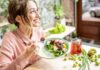 Deadly Nutrient Deficit Hiding In Healthy Diets Woman eating a fresh salad at a bright cafe