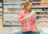 Midlife Menu – Late-Life Mood Shift? Woman reading a bottle label in a grocery store aisle