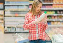 Midlife Menu – Late-Life Mood Shift? Woman reading a bottle label in a grocery store aisle