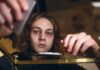 Why The Wrong Zip Code Derails Addiction Recovery young person leaning over a table with hands arranging items
