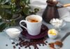 Berries, Cocoa, Coffee: The Recovery Hack Cup of coffee with milk, butter, and spices on a table