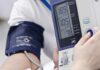 Sugary Gum Hack That Lowers Blood Pressure Person having blood pressure measured with digital monitor