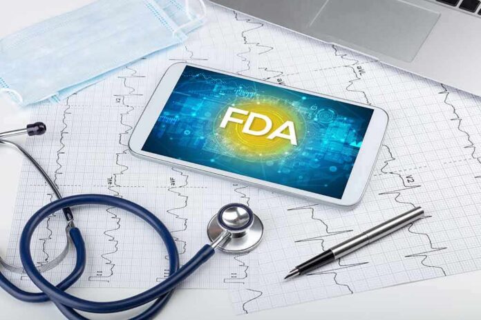 Tablet with FDA on screen amid medical tools and ECG charts