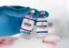 Estrogen Years Tied To Stronger Lungs Gloved hand holding estrogen and testosterone vials