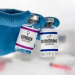 Estrogen Years Tied To Stronger Lungs Gloved hand holding estrogen and testosterone vials