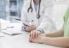 Doctor holding a patient's hands during consultation