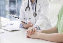 Why A Doctors’ “Normal” Warning Quietly Kills Care Doctor holding a patient's hands during consultation